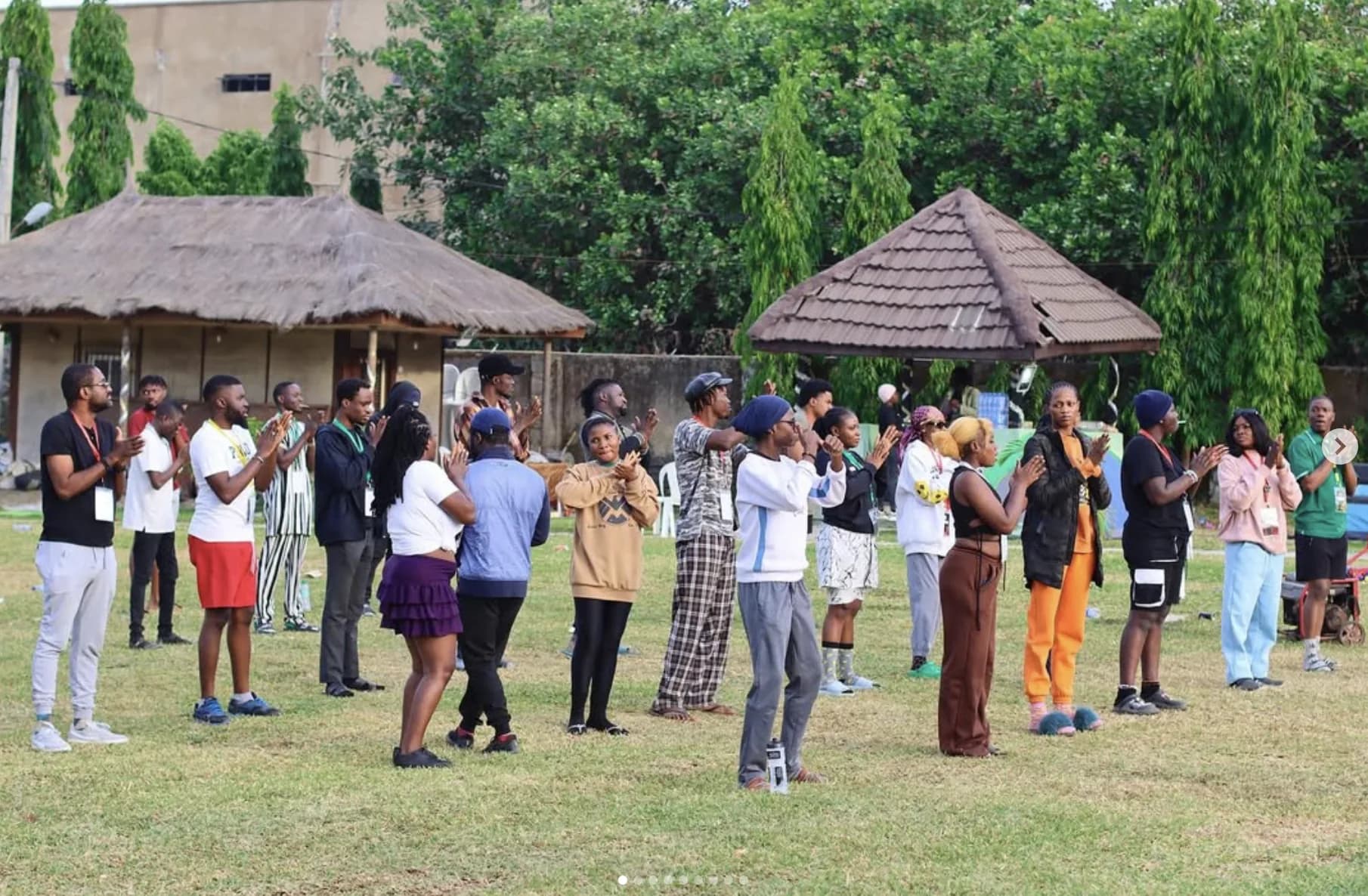 A large group gathered in a circle during an outdoor activity