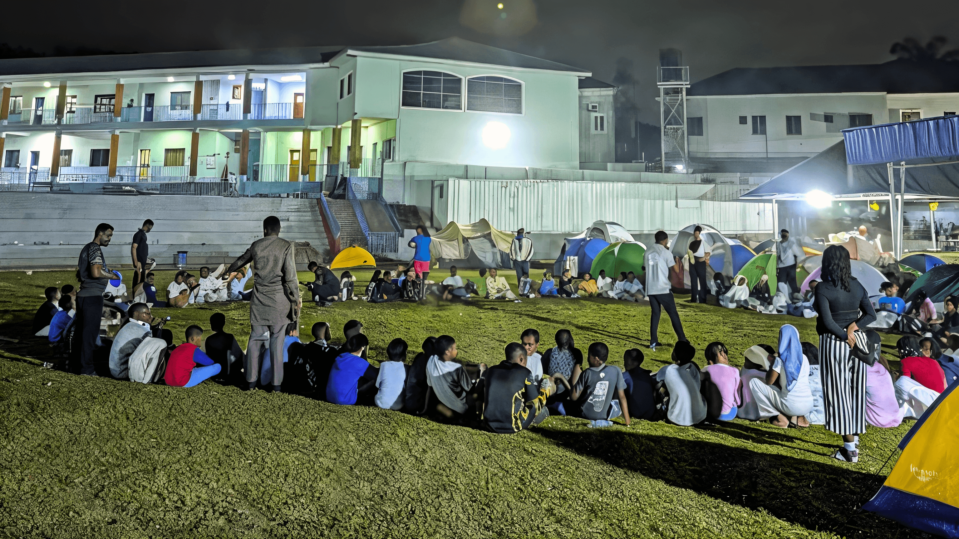 Students gathered around a campfire during an outdoor learning expedition